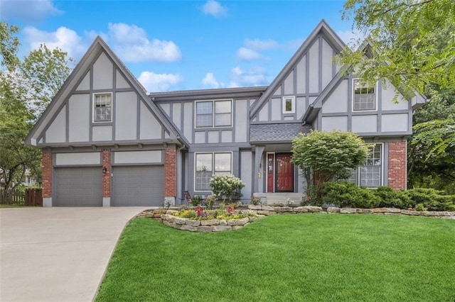 12117 Knox St, Overland Park, KS 66213 - tudor home with brick siding, a front yard, concrete driveway, an attached garage, and stucco siding