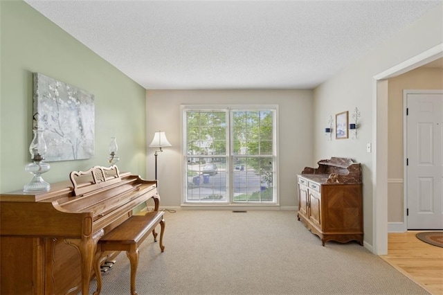12117 Knox St, Overland Park, KS 66213 - sitting room with a textured ceiling and light carpet
