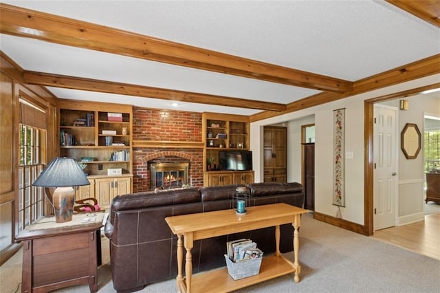12117 Knox St, Overland Park, KS 66213 - carpeted living area with beamed ceiling, plenty of natural light, a fireplace, and built in features