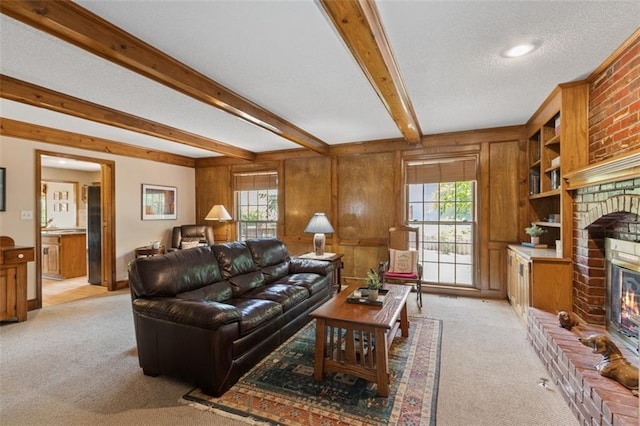 12117 Knox St, Overland Park, KS 66213 - living area with light colored carpet, a brick fireplace, plenty of natural light, beam ceiling, and wooden walls