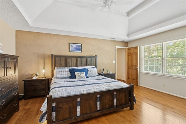 12117 Knox St, Overland Park, KS 66213 - bedroom featuring a tray ceiling, wood finished floors, and a ceiling fan