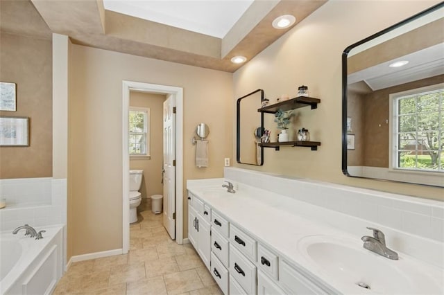 12117 Knox St, Overland Park, KS 66213 - bathroom featuring a garden tub, plenty of natural light, double vanity, and recessed lighting