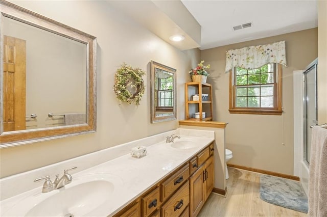 12117 Knox St, Overland Park, KS 66213 - full bath with plenty of natural light, double vanity, and wood finished floors