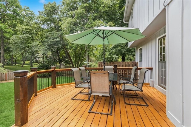 12117 Knox St, Overland Park, KS 66213 - wooden deck featuring outdoor dining area, view of wooded area, and a lawn