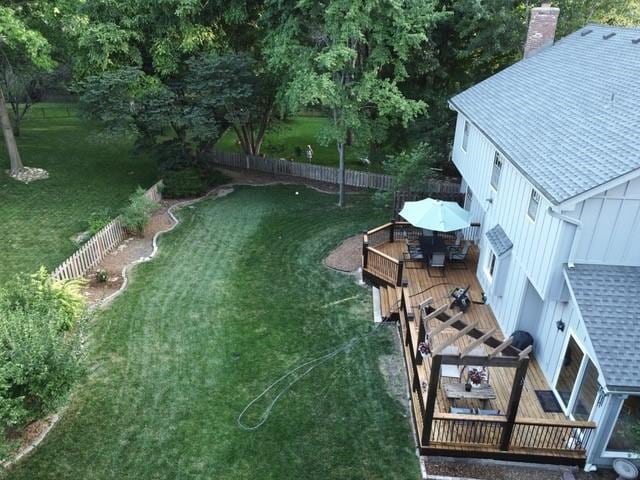 12117 Knox St, Overland Park, KS 66213 - fenced backyard with a wooden deck and outdoor dining space