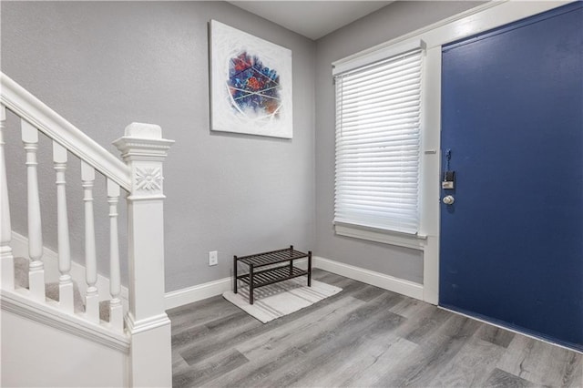 3221 E 11th St, Kansas City, MO 64127 - foyer entrance featuring wood finished floors and stairway
