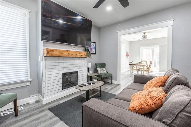 3221 E 11th St, Kansas City, MO 64127 - living area with a ceiling fan, wood finished floors, a fireplace, and recessed lighting