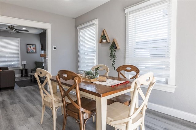 3221 E 11th St, Kansas City, MO 64127 - dining room with light wood-style floors and ceiling fan