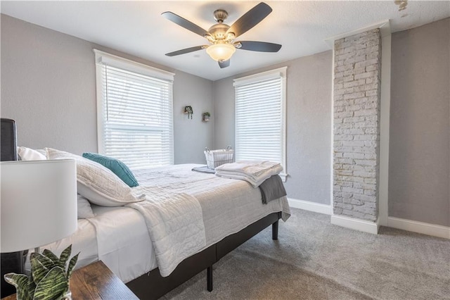 3221 E 11th St, Kansas City, MO 64127 - carpeted bedroom with multiple windows and ceiling fan