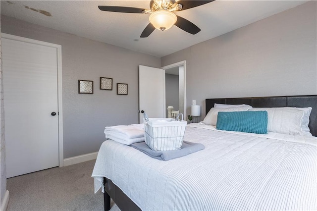 3221 E 11th St, Kansas City, MO 64127 - carpeted bedroom featuring baseboards and a ceiling fan