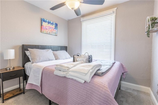 3221 E 11th St, Kansas City, MO 64127 - carpeted bedroom featuring baseboards and a ceiling fan