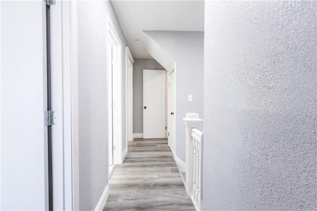 3221 E 11th St, Kansas City, MO 64127 - corridor with a textured wall and wood finished floors