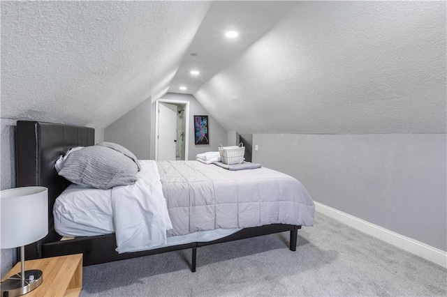 3221 E 11th St, Kansas City, MO 64127 - bedroom featuring vaulted ceiling, a textured ceiling, carpet floors, and recessed lighting