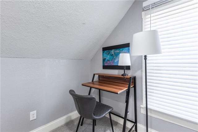 3221 E 11th St, Kansas City, MO 64127 - carpeted home office with lofted ceiling, a textured ceiling, and a textured wall