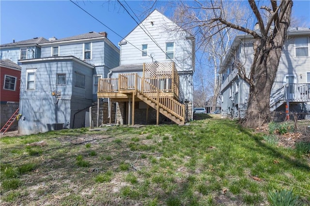 3221 E 11th St, Kansas City, MO 64127 - back of property featuring stairway and a wooden deck
