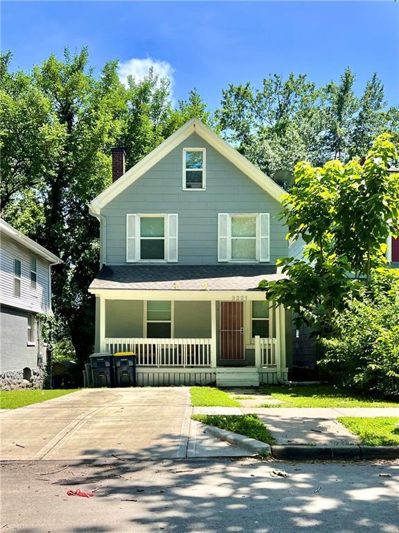 3221 E 11th St, Kansas City, MO 64127 - american foursquare style home with covered porch and a chimney