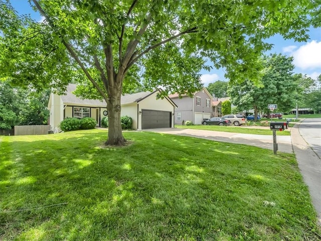 1914 S Leslie Dr, Independence, MO 64055 - view of front facade featuring concrete driveway and a garage