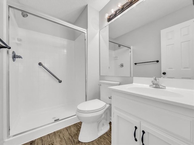 1914 S Leslie Dr, Independence, MO 64055 - bathroom featuring a stall shower, vanity, and wood finished floors