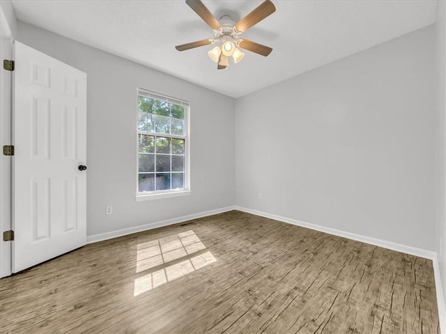 1914 S Leslie Dr, Independence, MO 64055 - spare room with wood finished floors and a ceiling fan