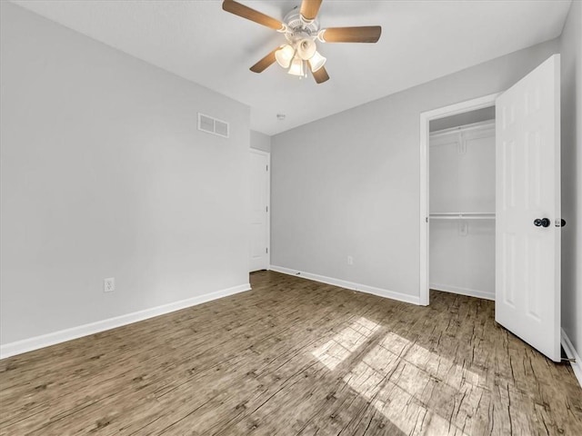 1914 S Leslie Dr, Independence, MO 64055 - unfurnished bedroom with wood finished floors, a closet, and ceiling fan
