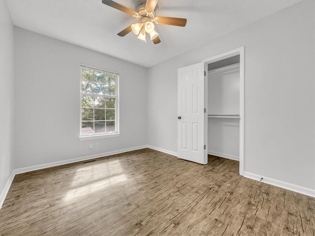 1914 S Leslie Dr, Independence, MO 64055 - unfurnished bedroom featuring wood finished floors, a closet, and a ceiling fan