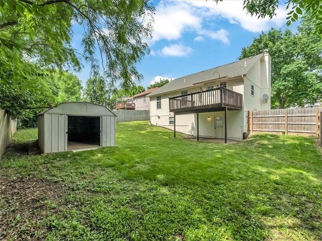 1914 S Leslie Dr, Independence, MO 64055 - rear view of property featuring a storage shed, a fenced backyard, and a deck