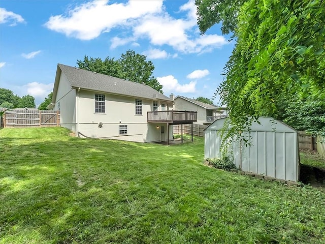 1914 S Leslie Dr, Independence, MO 64055 - rear view of property featuring a shed, a fenced backyard, a deck, and stucco siding