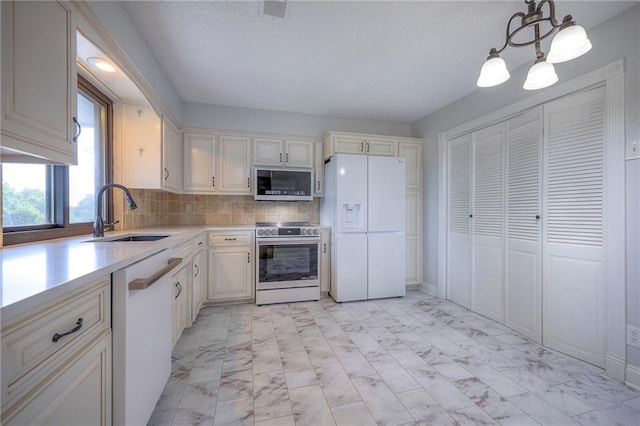 12818 W 110th Ter, Overland Park, KS 66210 - kitchen with white appliances, light marble finish floors, light countertops, and decorative backsplash