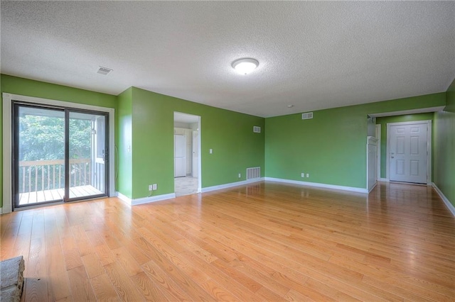 12818 W 110th Ter, Overland Park, KS 66210 - unfurnished room with a textured ceiling and light wood finished floors