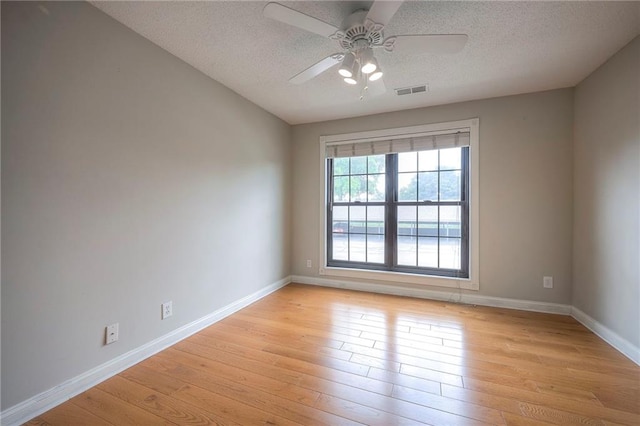 12818 W 110th Ter, Overland Park, KS 66210 - spare room featuring ceiling fan, a textured ceiling, and light wood-style flooring