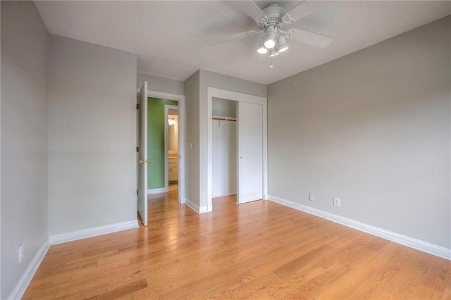 12818 W 110th Ter, Overland Park, KS 66210 - unfurnished bedroom featuring light wood-style flooring, a closet, and a ceiling fan