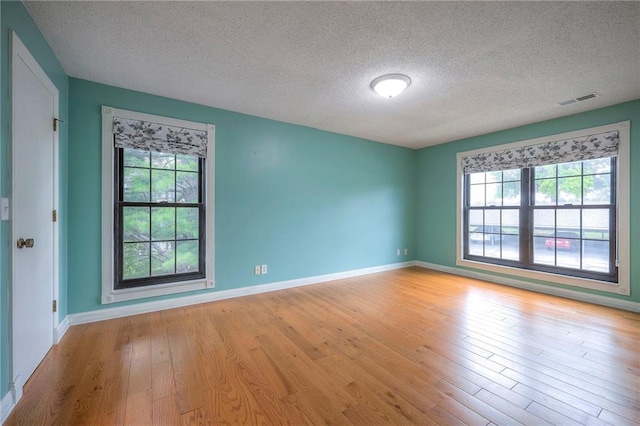 12818 W 110th Ter, Overland Park, KS 66210 - unfurnished room with a textured ceiling and light wood-style flooring