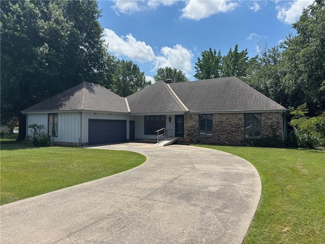 603 Lakeside Ct, Girard, KS 66743 - single story home with curved driveway, a front yard, board and batten siding, and an attached garage