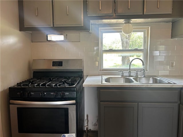 2587 Crk 2200, Caney, KS 67333 - kitchen with stainless steel range with gas cooktop, backsplash, and light countertops