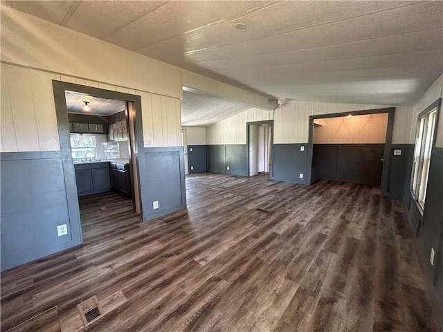 2587 Crk 2200, Caney, KS 67333 - unfurnished living room featuring dark wood-style floors and lofted ceiling