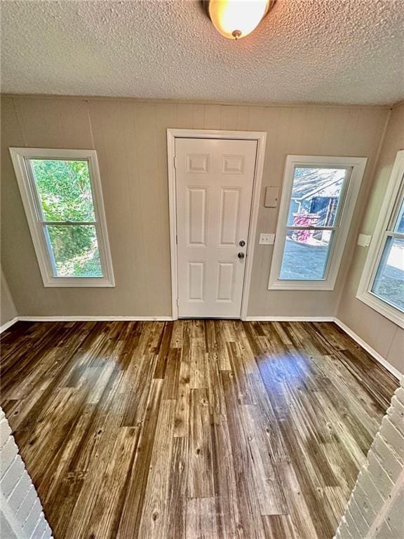 537 S Brookside Ave, Independence, MO 64053 - foyer with wood finished floors and a textured ceiling