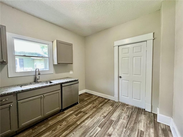 537 S Brookside Ave, Independence, MO 64053 - kitchen featuring dishwasher, gray cabinetry, dark wood finished floors, a textured ceiling, and light stone counters