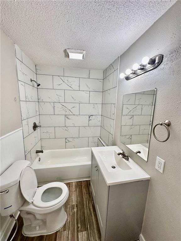 537 S Brookside Ave, Independence, MO 64053 - bathroom featuring a textured ceiling, wood finished floors, vanity, and shower / bath combination