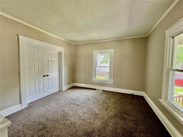 537 S Brookside Ave, Independence, MO 64053 - unfurnished bedroom with a textured ceiling, dark carpet, and ornamental molding