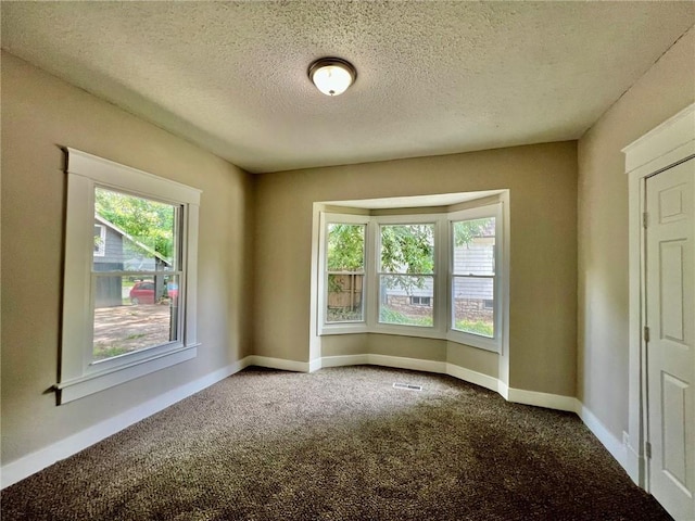 537 S Brookside Ave, Independence, MO 64053 - carpeted empty room with healthy amount of natural light and a textured ceiling