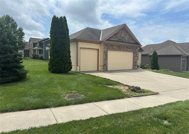 1703 Esther Dr, Kearney, MO 64060 - view of front of property featuring an attached garage, concrete driveway, a front lawn, and stone siding