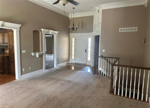 1703 Esther Dr, Kearney, MO 64060 - foyer featuring carpet flooring, crown molding, a ceiling fan, ornate columns, and a towering ceiling