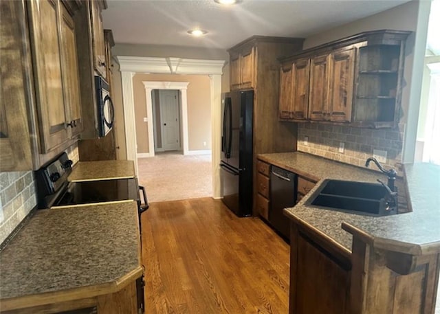1703 Esther Dr, Kearney, MO 64060 - kitchen with black appliances, decorative backsplash, dark wood-style floors, a peninsula, and open shelves