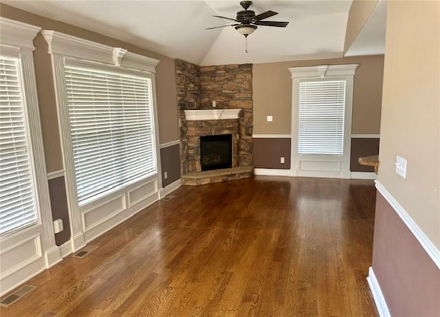 1703 Esther Dr, Kearney, MO 64060 - unfurnished living room featuring a ceiling fan, a stone fireplace, wood finished floors, and lofted ceiling