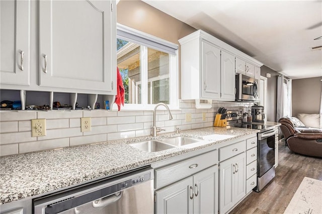 1433 Haskell Rd, Williamsburg, KS 66095 - kitchen with appliances with stainless steel finishes, open floor plan, wood finished floors, and decorative backsplash