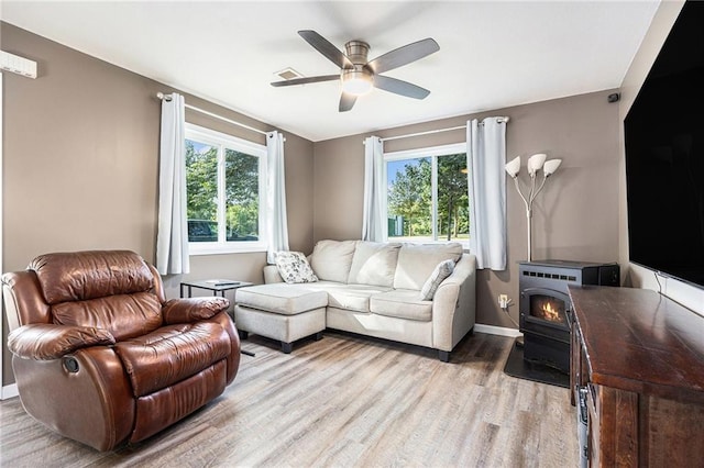 1433 Haskell Rd, Williamsburg, KS 66095 - living room with light wood-type flooring, ceiling fan, and a wood stove