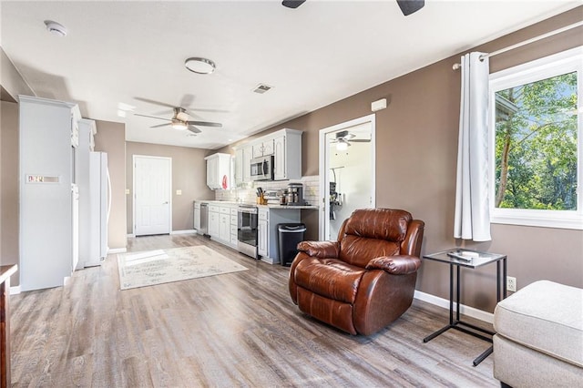 1433 Haskell Rd, Williamsburg, KS 66095 - living room with ceiling fan, light wood-style flooring, and beverage cooler