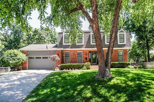 9718 W 115th Ter, Overland Park, KS 66210 - view of front of house featuring brick siding, an attached garage, concrete driveway, and roof with shingles