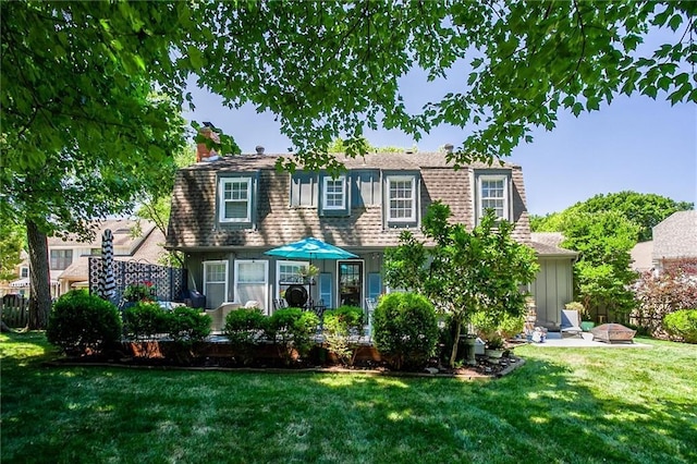 9718 W 115th Ter, Overland Park, KS 66210 - view of front of home with a chimney, a front yard, and a shingled roof