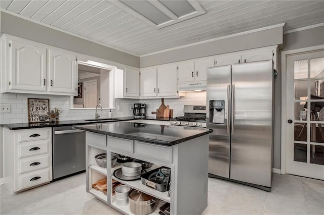 9718 W 115th Ter, Overland Park, KS 66210 - kitchen with appliances with stainless steel finishes, under cabinet range hood, open shelves, backsplash, and light tile patterned floors